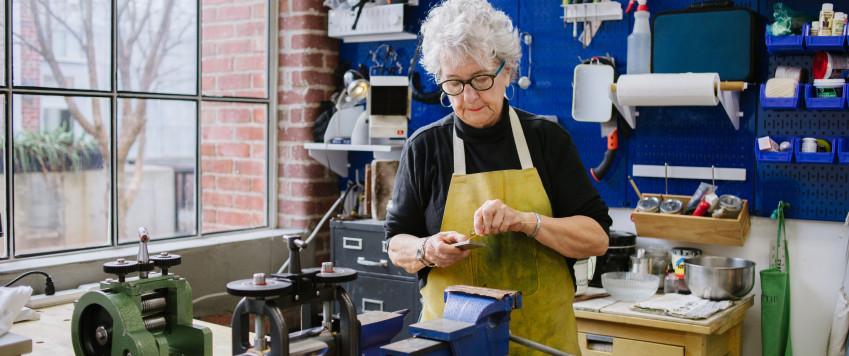 Art Jeweler Working in Studio 